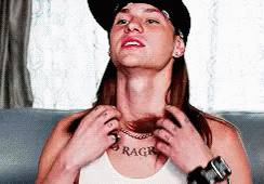 Long Haired Man Showing No Regrets Chest Tattoo  GIF