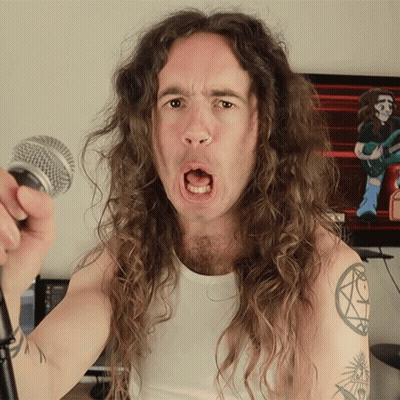 Long Haired Man Singing Into Microphone With Arm Tattoo GIF