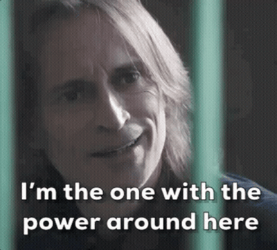 Long-Haired Man Smiling Behind Fence Says I'm The One With The Power Around Here GIF