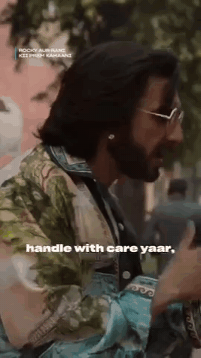Long-Haired Man With Beard And Sunglasses In Floral Shirt Talking GIF