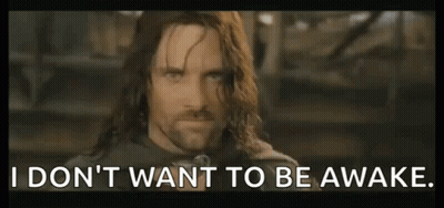 Long-Haired Man With Sign I Don't Want To Be Awake GIF