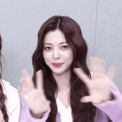Long Haired Woman In Purple Sweater Giving Peace Sign GIF