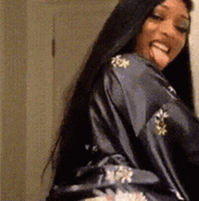 Long-Haired Woman In Robe Sticking Out Tongue GIF
