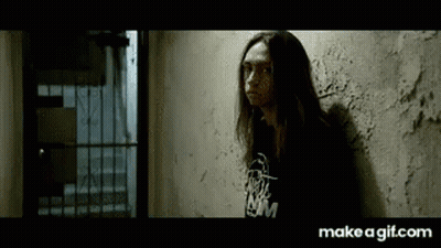Long Haired Woman Leaning Wall Black Shirt NM GIF