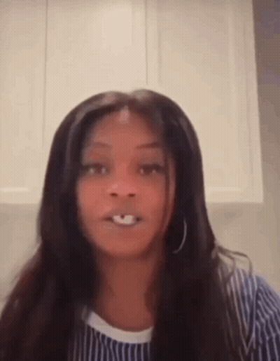 Long-Haired Woman Making Funny Face In Striped Shirt GIF