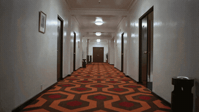 Long Hallway With Red And Brown Carpet And Picture GIF