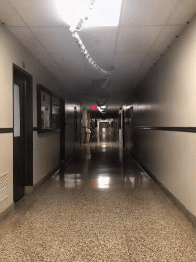 Long Hallway With Red Exit Sign GIF