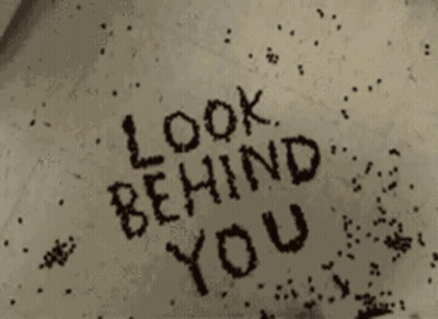 Look Behind You Is Written In Black Letters On A White Surface GIF