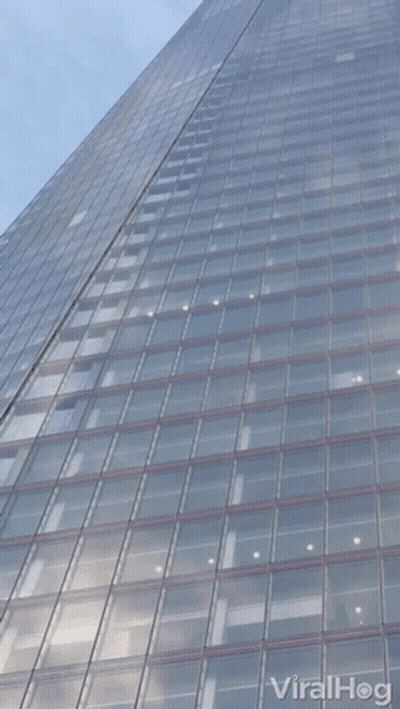 Looking Up At A Tall Building With Viralhog Written On The Bottom Right GIF