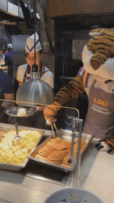 LSU Mascot Serving Pancakes To Woman GIF