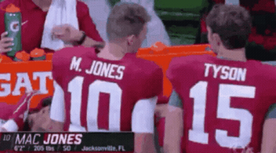 Mac Jones And Tyson Sitting In Stands GIF