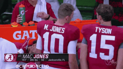 Mac Jones And Tyson Sitting On Sidelines GIF