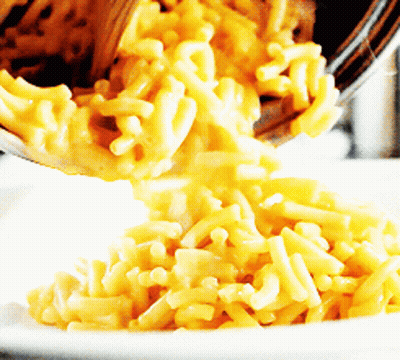 Macaroni And Cheese Being Poured Into A White Plate GIF