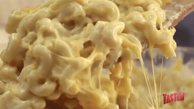 Macaroni And Cheese Is Being Scooped Out Of A Bowl GIF
