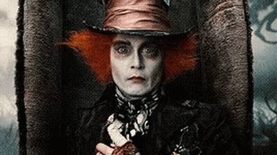 Mad Hatter Sitting In Chair Holding Knife GIF