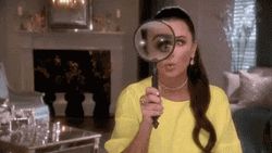 Magnifying Glass Amazes Yellow Lady GIF
