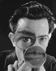 Magnifying Glass Moving Over Black And White Picture GIF