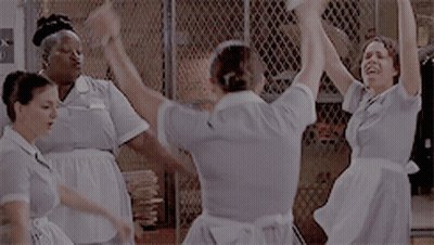 Maids Dancing In Front Of Bank Sign GIF