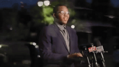 Malachi Love-Robinson In Suit At Microphones GIF