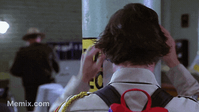 Man Adjusts Hair Near EC Sign GIF