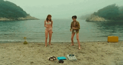 Man And A Woman In A Funny Beach GIF