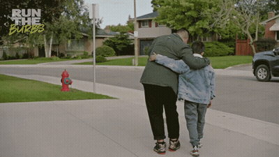 Man And Boy Hugging On Sidewalk Run The Burbs GIF