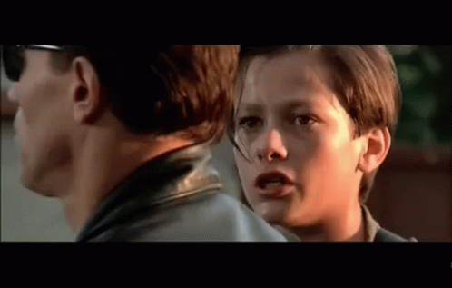 Man And Boy Looking At Each Other In Movie GIF