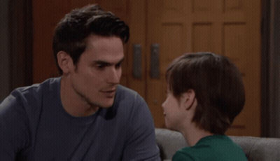 Man And Boy Looking At Each Other On Couch GIF