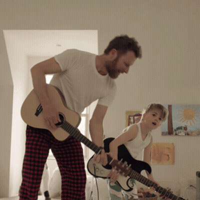 Man and Boy Playing Guitars