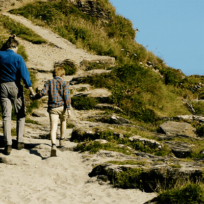 Man And Boy Walking Up Hill Holding Hands GIF