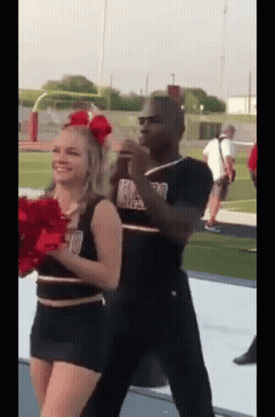 Man And Cheerleader Dancing On Football Field GIF