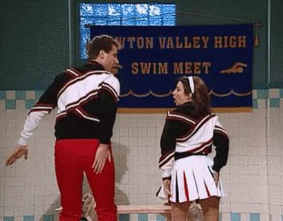 Man And Cheerleader In Front Of Swim Meet Banner GIF