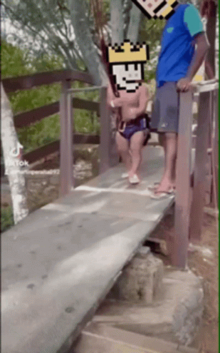 Man And Child Standing On Wooden Bridge With Pixelated Face GIF