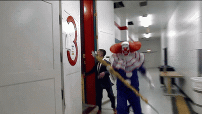 Man And Clown Running Down Hallway With Number 3 GIF
