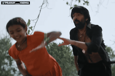 Man And Girl Dancing In Front Of Pranay Varma Sign GIF