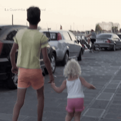 Man And Little Girl Holding Hands At La Guarimba Festival GIF
