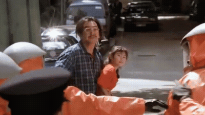 Man And Little Girl Walking Past Orange Jacket Group GIF