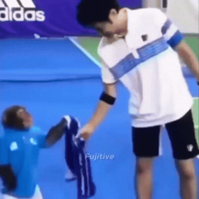 Man And Monkey On Tennis Court GIF