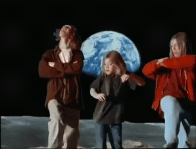 Man And Two Girls Dancing On Moon In Front Of Blue Planet GIF