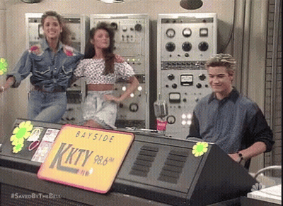 Man And Two Women In Front Of Bayside KKTY 98.6 Sign GIF