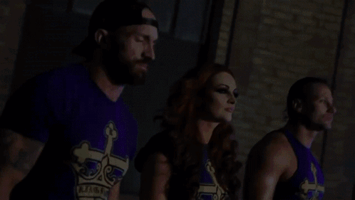 Man And Two Women In Purple Shirts With Crown Standing Together GIF
