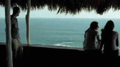 Man And Two Women Looking Over Water GIF