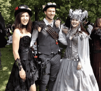 Man And Two Women Posing In Park GIF