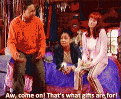 Man And Two Women Sitting On Bed Saying Aw Come On Thats What Gifts Are For GIF