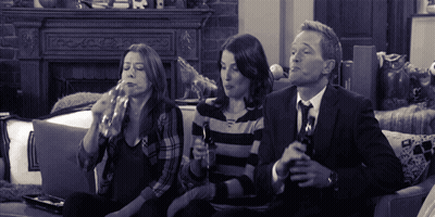 Man And Two Women Sitting On Couch Drinking GIF