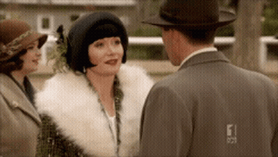 Man And Two Women Standing And Talking GIF