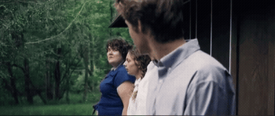 Man And Two Women Standing In Front Of A House GIF