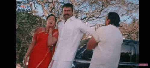 Man And Two Women Standing Next To Car GIF