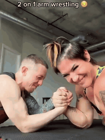 Man And Woman Arm Wrestling 2 On 1 GIF