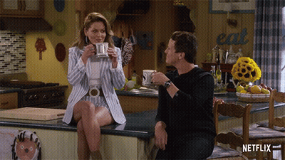 Man And Woman At Kitchen Counter Saying Eat GIF